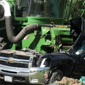 Chevy silverado smashed by field harvester
